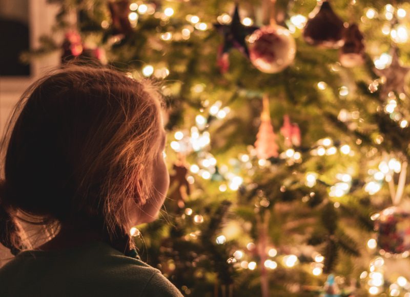 Girl looking at christmas tree