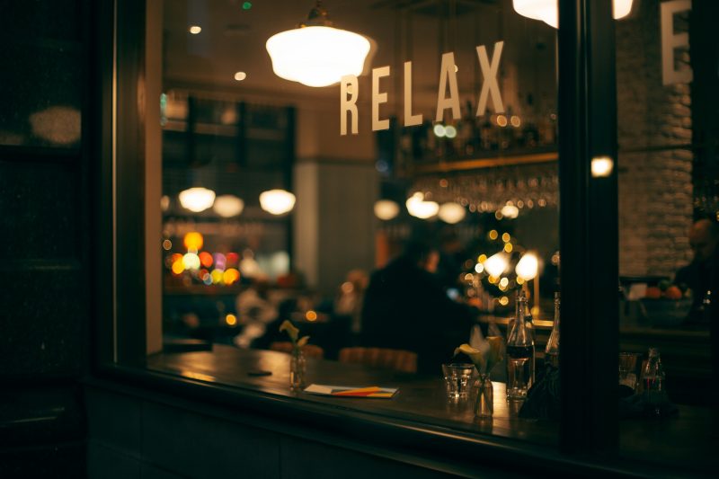 Bar in dim light with sign saying relax