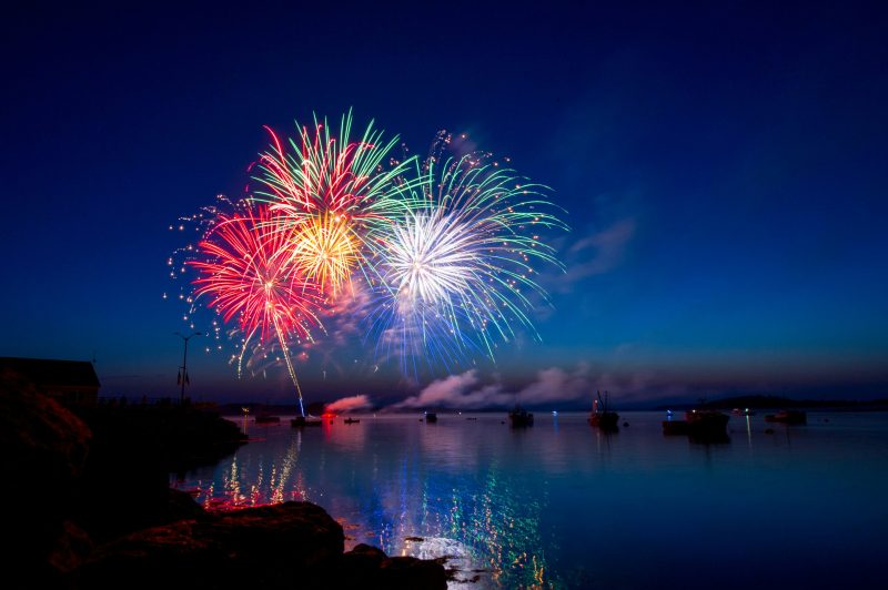 A fireworks display in the harbor of Lubec Maine. The dusk sky, water and boats provided a beautiful setting for the colorful show.