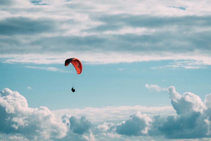 Parachute flying over clouds