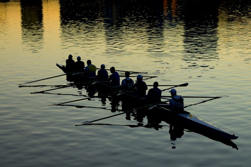 Rowing boat with team in sunset
